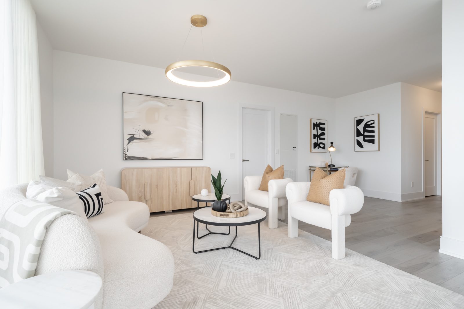 Bright living room with a ring pendant and gallery art