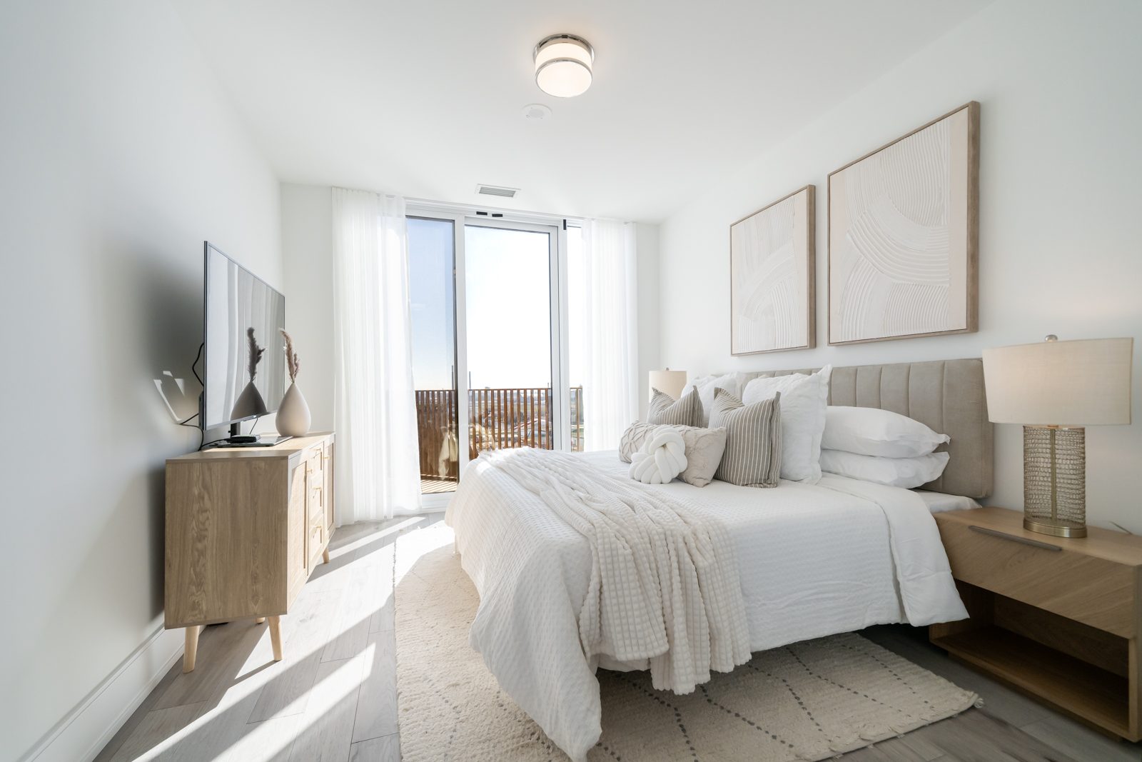 Sunlit bedroom with a walk-out balcony
