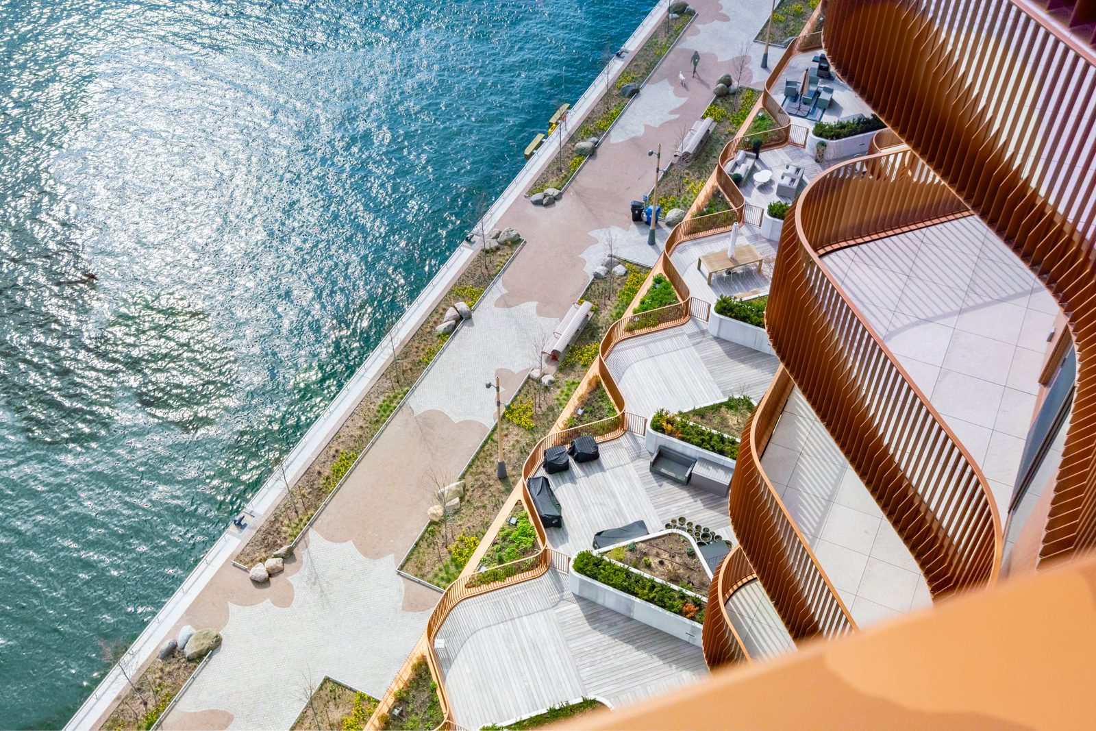 Aerial view of curved balconies and the waterfront promenade